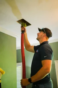 A technician performing air duct cleaning in Tallahassee