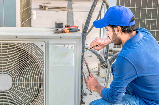 A professional repairing an AC system